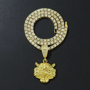 Close-up van een vergulde 3D tijgerkop hanger aan een diamanten tennis ketting