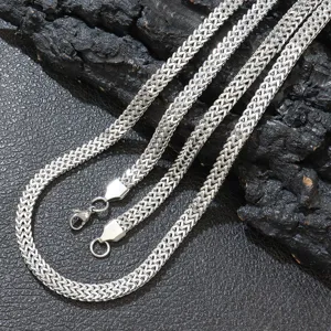 Detailed macro shot of silver stainless steel double-row Franco chain necklace.