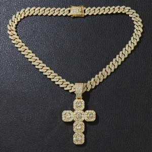Detailed view of gold iced-out cross pendant on a sparkly Cuban link chain