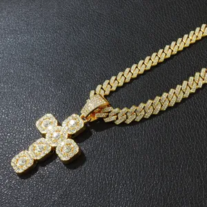 Detailed macro view of a gold-finished iced out cross pendant on a Cuban link chain