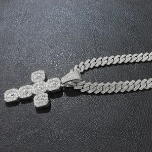 Close-up detail of silver iced-out cross pendant and cuban link chain with rhinestones