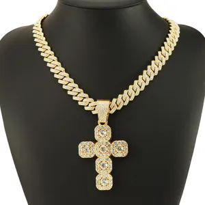 Close-up detail of iced out gold cross pendant on a diamond-set Cuban link chain.