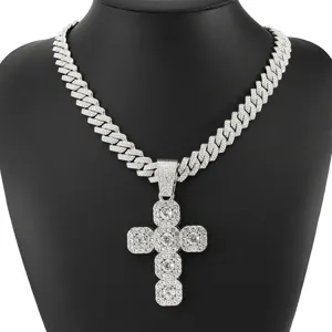 Detailed macro view of a silver iced-out cross pendant with shiny cubic zirconia stones.