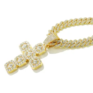 Detailed macro view of iced-out gold cross pendant on a diamond-set cuban link chain
