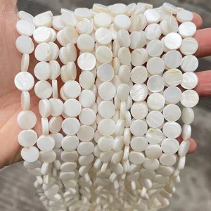 Dettaglio di perle tonde in madreperla naturale bianca da 12mm per gioielli fai da te
