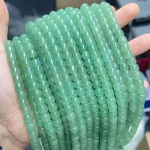 Close-up detail of natural green aventurine barrel shaped loose beads for DIY jewelry