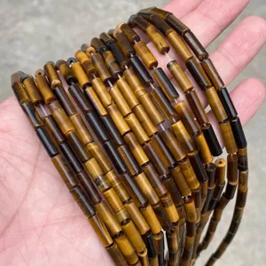 High quality macro detail of natural 4x13mm tiger's eye stone cylindrical tube beads