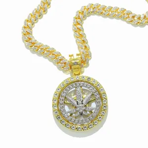Detailed macro view of hip hop iced out spinning maple leaf pendant with golden cuban chain