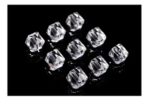 Macro detail showing the diamond facets of clear crystal cube beads for DIY jewelry.