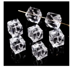 Macro detail view of high-quality faceted clear quartz crystal cube beads for DIY jewelry