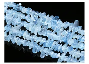 Detailed macro view of natural light blue aquamarine crushed stone beads for DIY.
