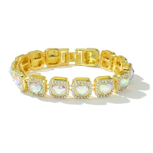 Detail of gold Cuban link bracelet with iridescent heart-shaped stones and crystals