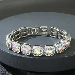 Close-up of hip hop bracelet with iridescent heart crystals and silver square links.
