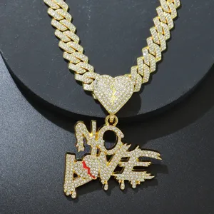 Detailed close-up of iced out NO LOVE letter pendant with broken heart and Cuban chain.