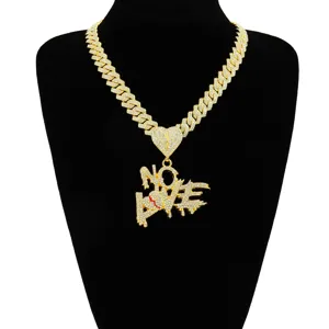 Detail of iced-out NO LOVE pendant necklace with golden Cuban link chain on black bust.