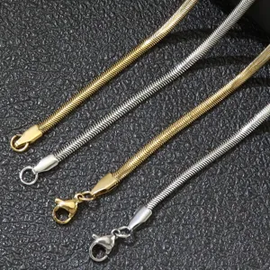 Close-up detail of 3mm wide stainless steel flat snake chain necklaces in gold and silver