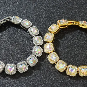Close-up detail of silver and gold hip-hop bracelets with iridescent heart crystals