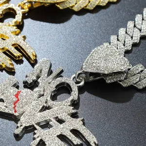 Close-up detail of iced-out rhinestone NO LOVE pendant and broken heart Cuban chain