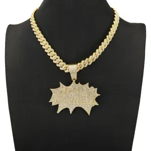 Close-up of iced-out gold BOM! pendant with rhinestone Cuban link chain necklace.