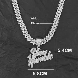 Macro detail of Stay Humble pendant on a 13mm silver iced out Cuban link chain
