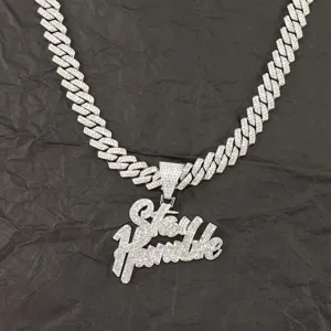 Close-up of iced-out Stay Humble pendant on a silver Cuban link chain necklace
