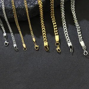 Detailed view of various gold and silver stainless steel Franco chains with lobster clasps
