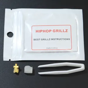 Package contents for single gold cross teeth grill with accessories and manual