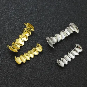 Set di grillz hip-hop denti da vampiro oro e argento su fondo nero testurizzato