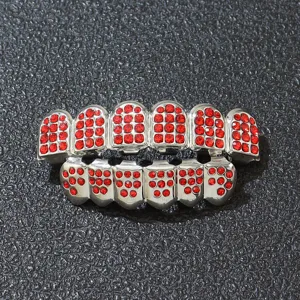 Close-up detail of silver hip hop teeth grills set with vibrant red rhinestones.