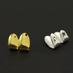 Detailed macro view of gold and silver hip hop fangs grillz with star cutouts
