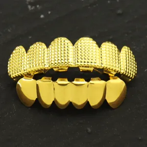 Detailed view of gold-plated hip-hop grillz featuring intricate textured grid patterns.