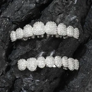 Detailed view of silver-toned hip-hop grillz with paved cubic zirconia stones