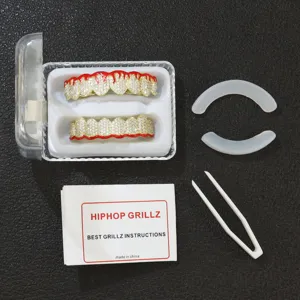 Detail view of hip hop grillz set featuring red flame pattern and pave crystal stones