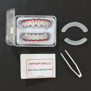 Macro detail view of hip hop grillz set featuring red dripping enamel and CZ stones