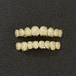 Detailed top view of gold hip hop teeth grillz iced out with cubic zirconia