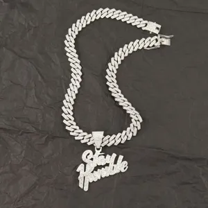Close-up detail of the Stay Humble iced out pendant on a silver Cuban link chain