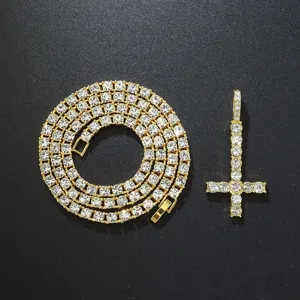 Detailed view of gold-plated iced out inverted cross pendant with matching tennis chain