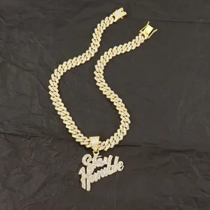 Top view of gold iced-out Stay Humble pendant on a cuban link chain for hip-hop style
