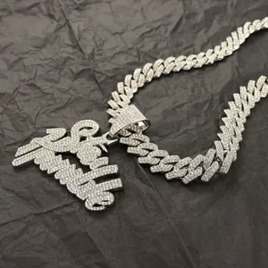 Detailed view of iced-out Stay Humble pendant on a sparkling rhinestone Cuban chain.