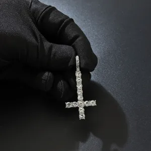 Close-up of iced out inverted cross pendant with sparkling rhinestones