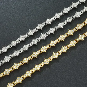 Nahaufnahme von Gold- und Silber-Tennisarmbändern mit Strass-Blumenkreuzmuster