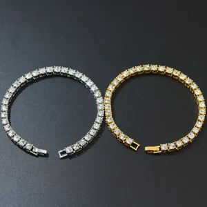 Close-up of gold and silver single row tennis bracelets with sparkling crystals