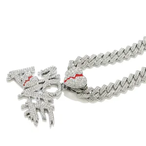 Close-up of hip hop iced out NO LOVE pendant with broken heart on silver Cuban chain