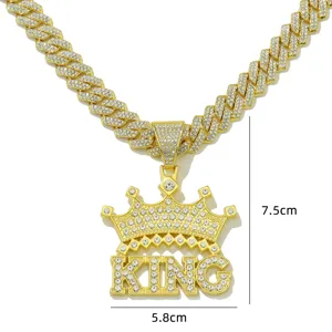 Detail of iced out gold crown KING pendant on thick Cuban link hip hop necklace chain.