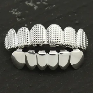 Macro view of checkered texture and polished silver hip-hop teeth grillz set for dental jewelry