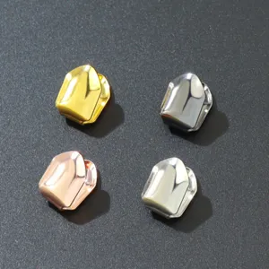 Detail showing four colors of smooth metallic single tooth grillz caps for hip hop fashion
