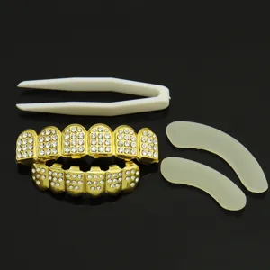 Detail view of 18K gold-plated hip-hop grills set with rhinestones and tweezers