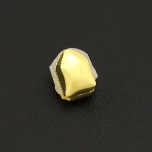 Detailed macro view of a single smooth gold-plated hip-hop tooth grill with silicone mold