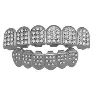 Close-up of premium silver hip hop grillz featuring iced out rhinestones and sharp fangs