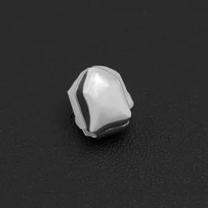 Detailed view of a shiny silver single tooth grillz cap with a smooth polished mirror finish.